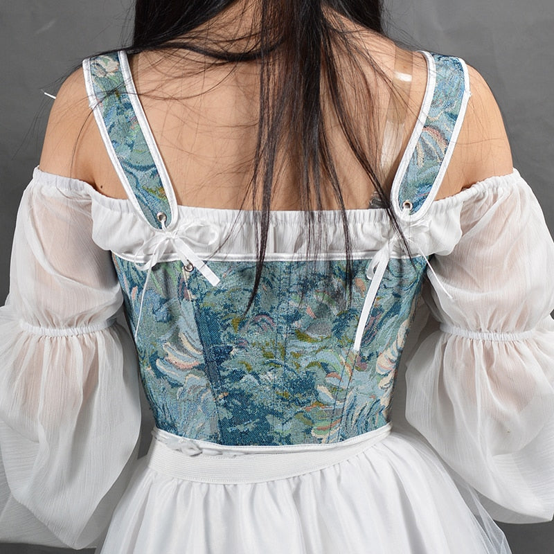 Niebieski gorset gobelinowy w kwiaty, widok z tyłu, z regulowanymi ramiączkami i eleganckim splotem, idealny do kreacji retro.